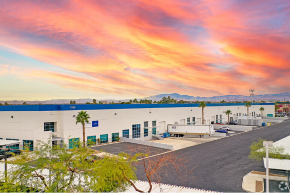 Colorful orange, blue and purple sunrise above a white and blue industrial facility | Caltrol, Inc., Clark County, Nevada